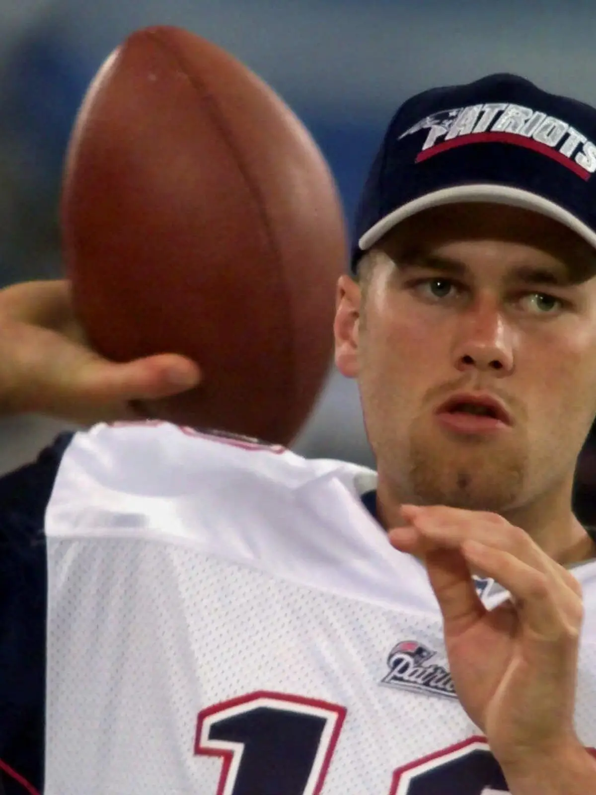 FILE - In this Aug. 4, 2000, file photo, New England Patriots backup quarterback Tom Brady warms up on the sidelines before an NFL football game against the Detroit Lions at the Silverdome in Pontiac, Mich. Brady grew from a sixth-round draft choice into one of the best quarterbacks in NFL history. On Tuesday, NFL commissioner Roger Goodell hears Brady's appeal of a four-game suspension for using deflated footballs in the AFC championship game. How will that affect Brady's legacy? (AP Photo/Carlos Osorio, File)