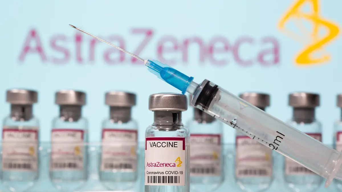 Vials labelled "AstraZeneca COVID-19 Coronavirus Vaccine" and a syringe are seen in front of a displayed AstraZeneca logo in this illustration taken March 10, 2021. REUTERS/Dado Ruvic/Illustration