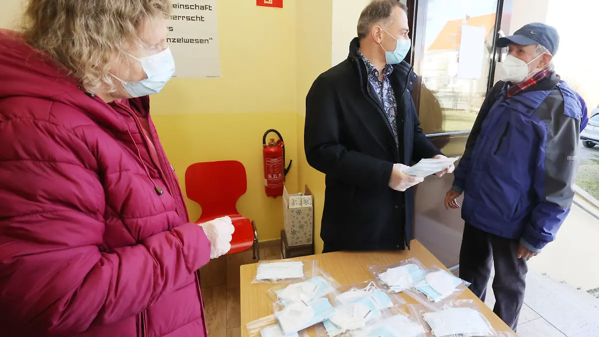 06.03.2021, Thüringen, Weimar: Petra Seidel (l-r), Ortsteilbürgermeisterin des Weimarer Stadtteils Legefeld, und Peter Kleine (Parteilos), Oberbürgermeister von Weimar, verteilen kostenlose OP-Masken und FFP2-Masken an die Einwohner der Stadt. Foto: Bodo Schackow/dpa-Zentralbild/dpa +++ dpa-Bildfunk +++