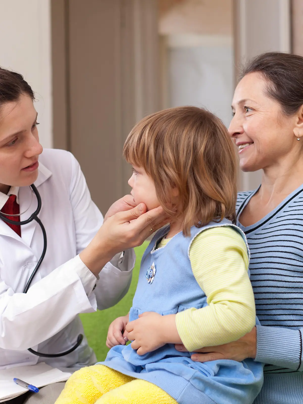 serious pediatrician doctor examining baby girl