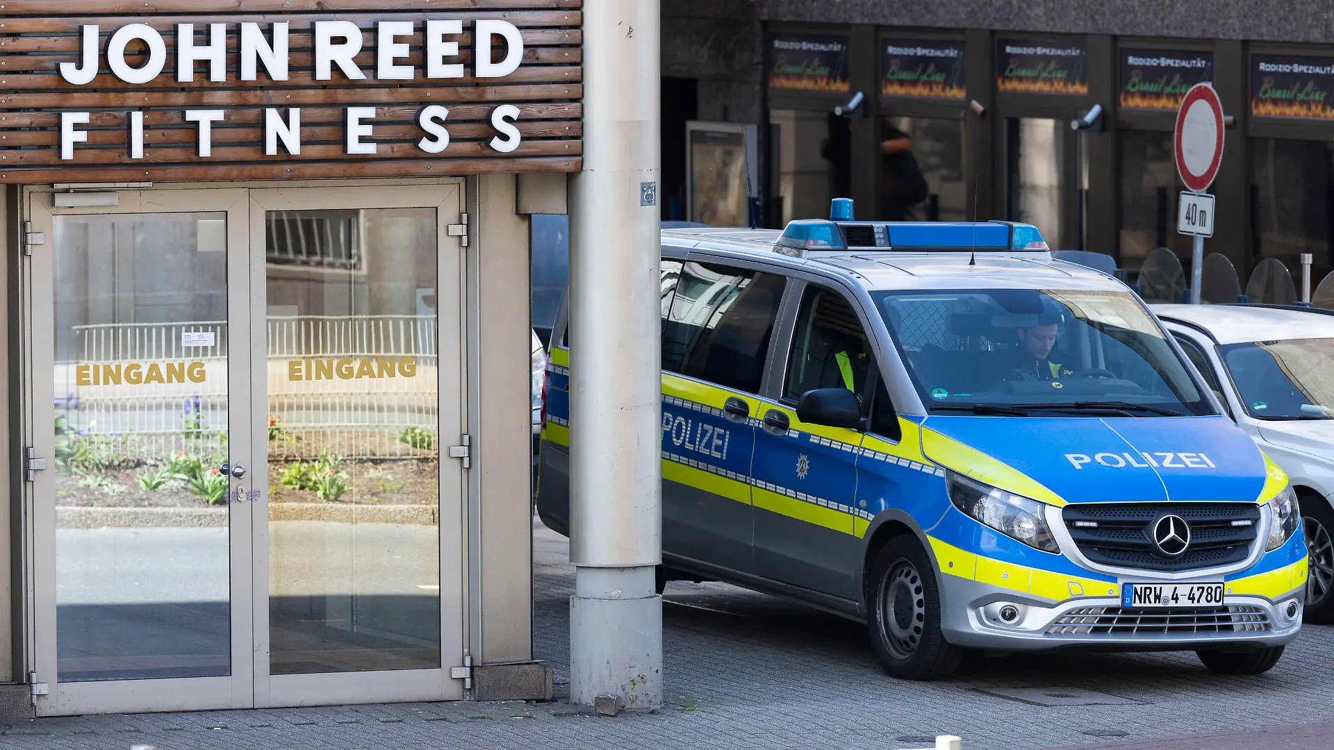 19.04.2023, Nordrhein-Westfalen, Duisburg: Ein Streifenwagen steht vor dem Eingang. Bei einer Attacke in einem Fitnessstudio in der Duisburger Innenstadt sind mehrere Personen schwer verletzt worden. Die Polizei sprach am Dienstagabend von «mindestens» einem Täter. Foto: Christoph Reichwein/dpa +++ dpa-Bildfunk +++