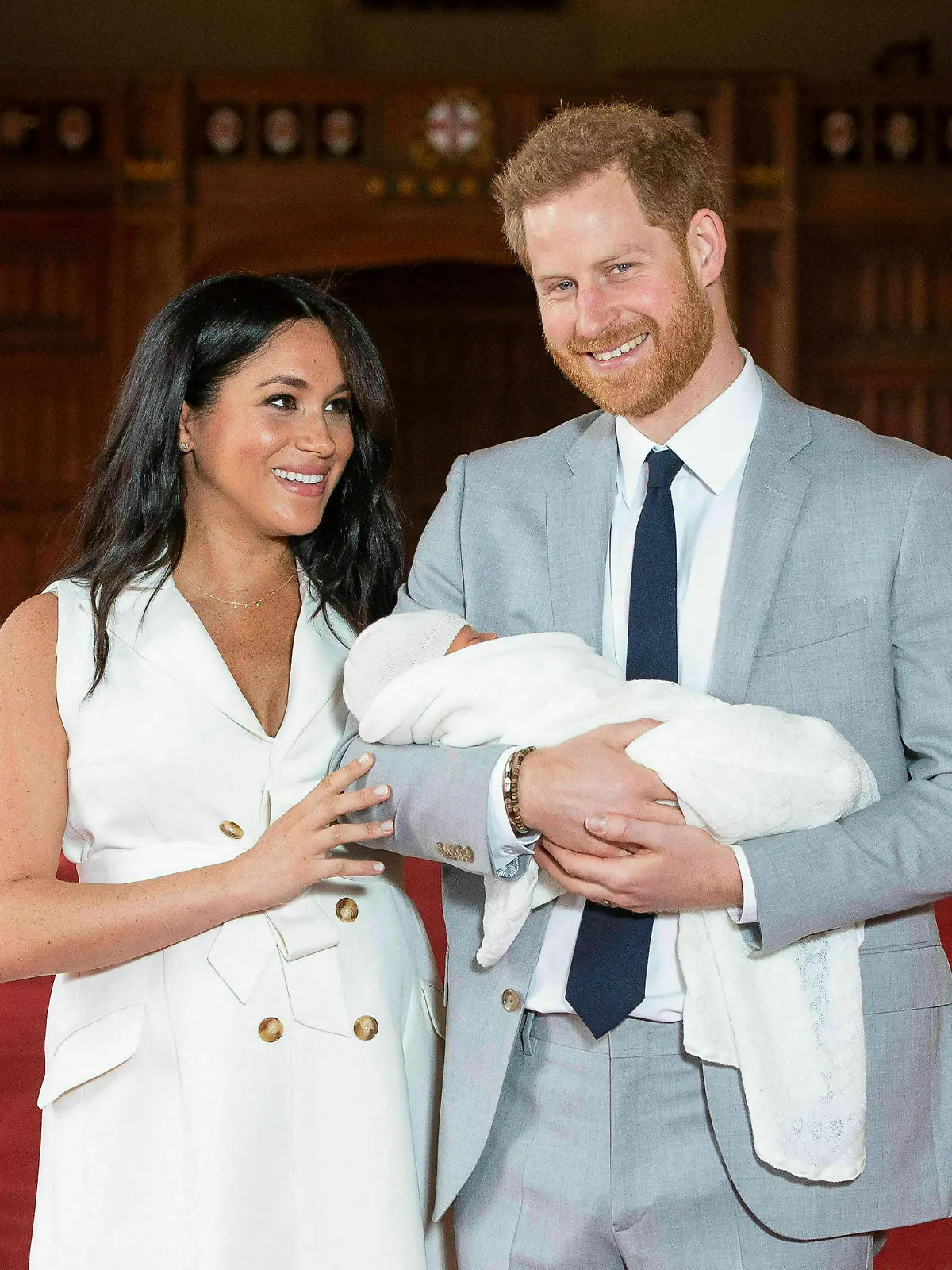 FILE - In this Wednesday May 8, 2019 file photo Britain's Prince Harry and Meghan, Duchess of Sussex, pose during a photocall with their newborn son Archie, in St George's Hall at Windsor Castle, Windsor, south England. The Duchess of Sussex has revealed that she had a miscarriage in July. Meghan described the experience in an opinion piece in the New York Times on Wednesday. She wrote: "I knew, as I clutched my firstborn child, that I was losing my second." The former Meghan Markle and husband Prince Harry have a son, Archie, born in 2019. (Dominic Lipinski/Pool via AP, File)