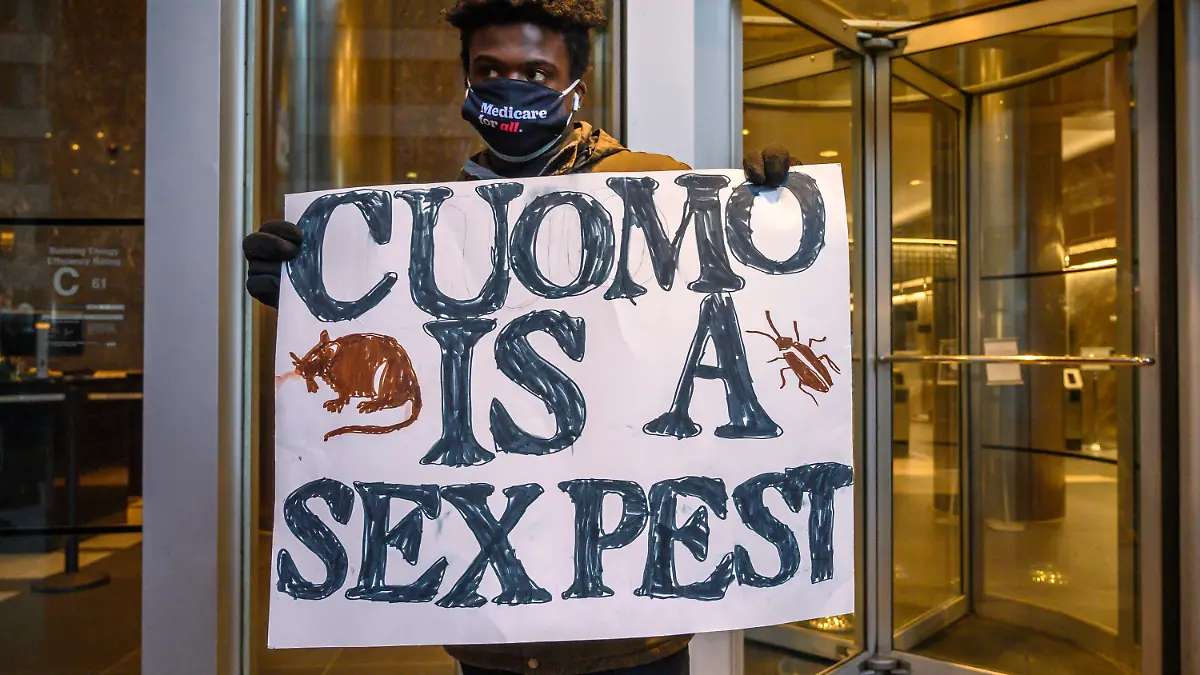 Isaiah Dawson, 22, and other demonstrators rally for New York Gov. Andrew Cuomo's resignation in front of his Manhattan office in New York, Tuesday, March 2, 2021. Cuomo has avoided public appearances for days as some members of his own party call for him to resign over sexual harassment allegations. (AP Photo/Brittainy Newman)
