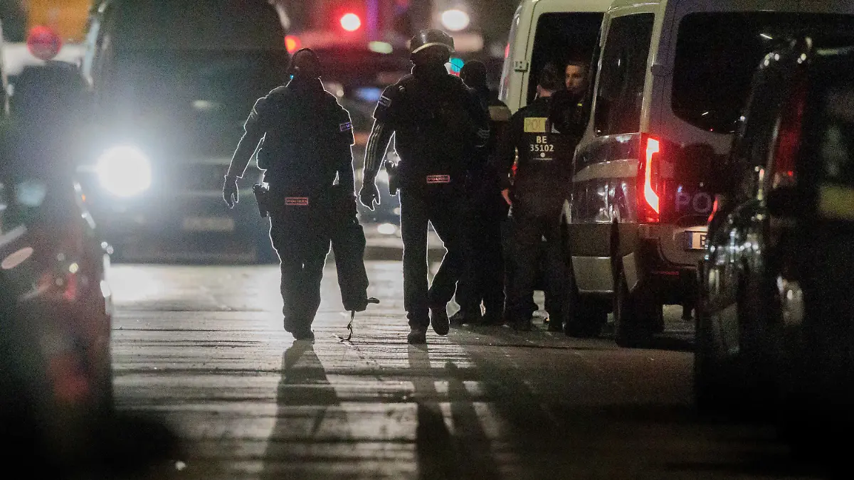 25.04.2023, Berlin: Polizisten gehen zu den Einsatzfahrzeugen nach der Beendigung einer Geiselnahme in einem Geschäft an der Keithstraße. Dort war es zu einem Überfall auf ein Geschäft gekommen, bei dem auch eine Geisel genommen wurde. Foto: Carsten Koall/dpa +++ dpa-Bildfunk +++