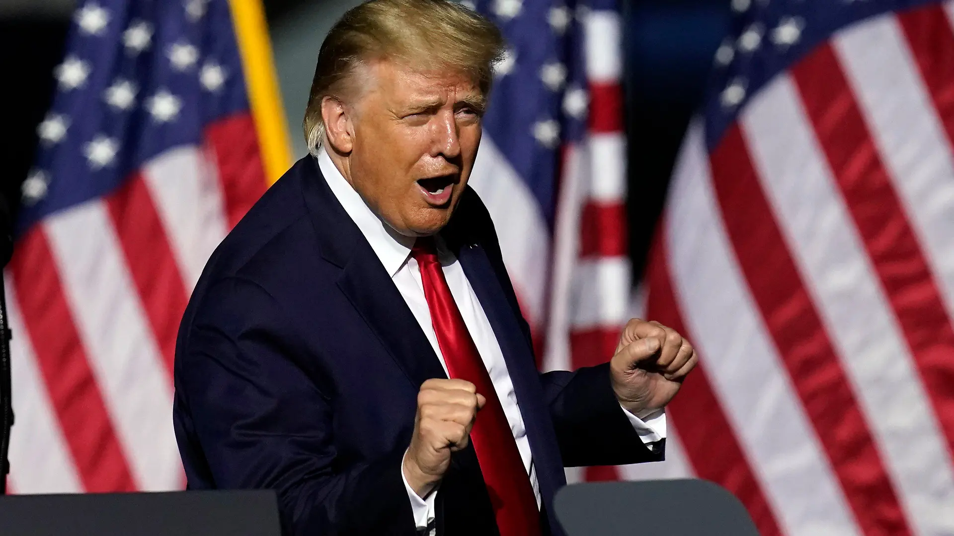 In this Sept. 25, 2020 photo, President Donald Trump does a little dance after speaking at a campaign rally in Newport News, Va. Trump, a man who is famously particular about his appearance, is fully embracing doing a dad dance to the Village People's “YMCA” as the finale to his rallies in the campaign's closing stretch. (AP Photo/Steve Helber)