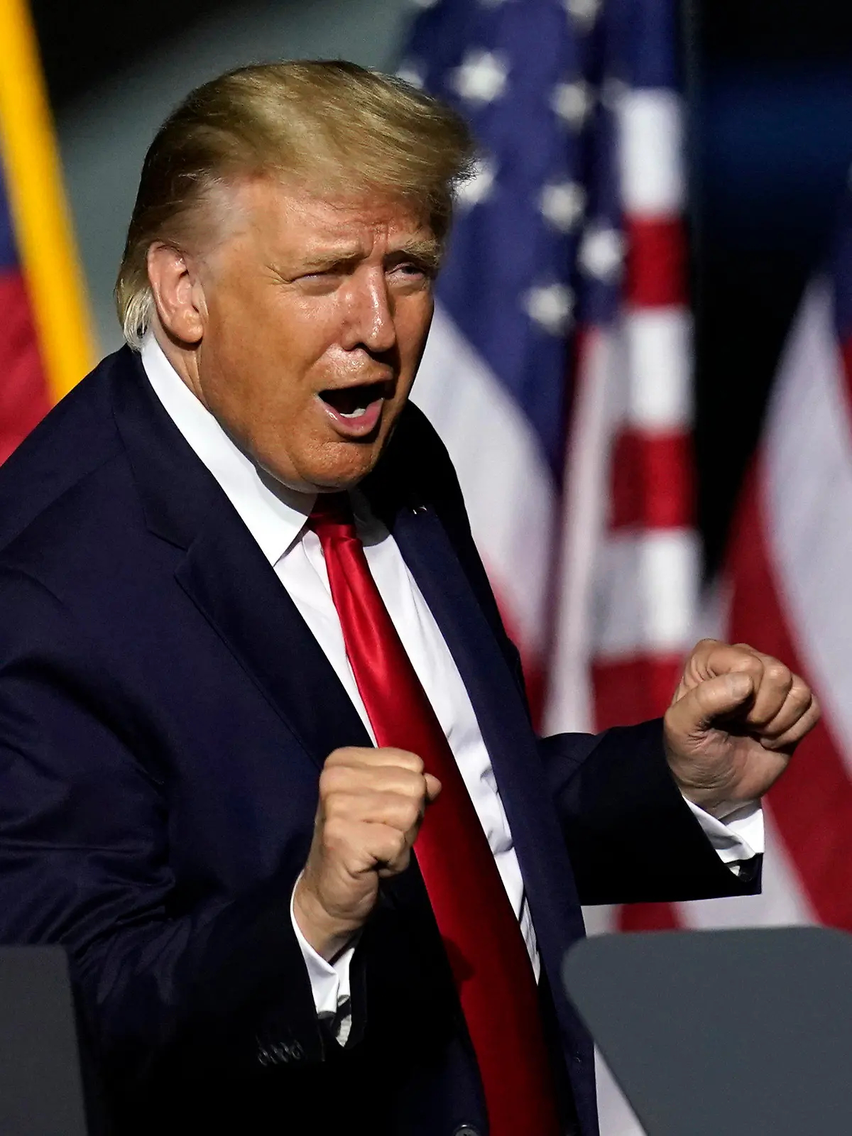 In this Sept. 25, 2020 photo, President Donald Trump does a little dance after speaking at a campaign rally in Newport News, Va. Trump, a man who is famously particular about his appearance, is fully embracing doing a dad dance to the Village People's “YMCA” as the finale to his rallies in the campaign's closing stretch.  (AP Photo/Steve Helber)
