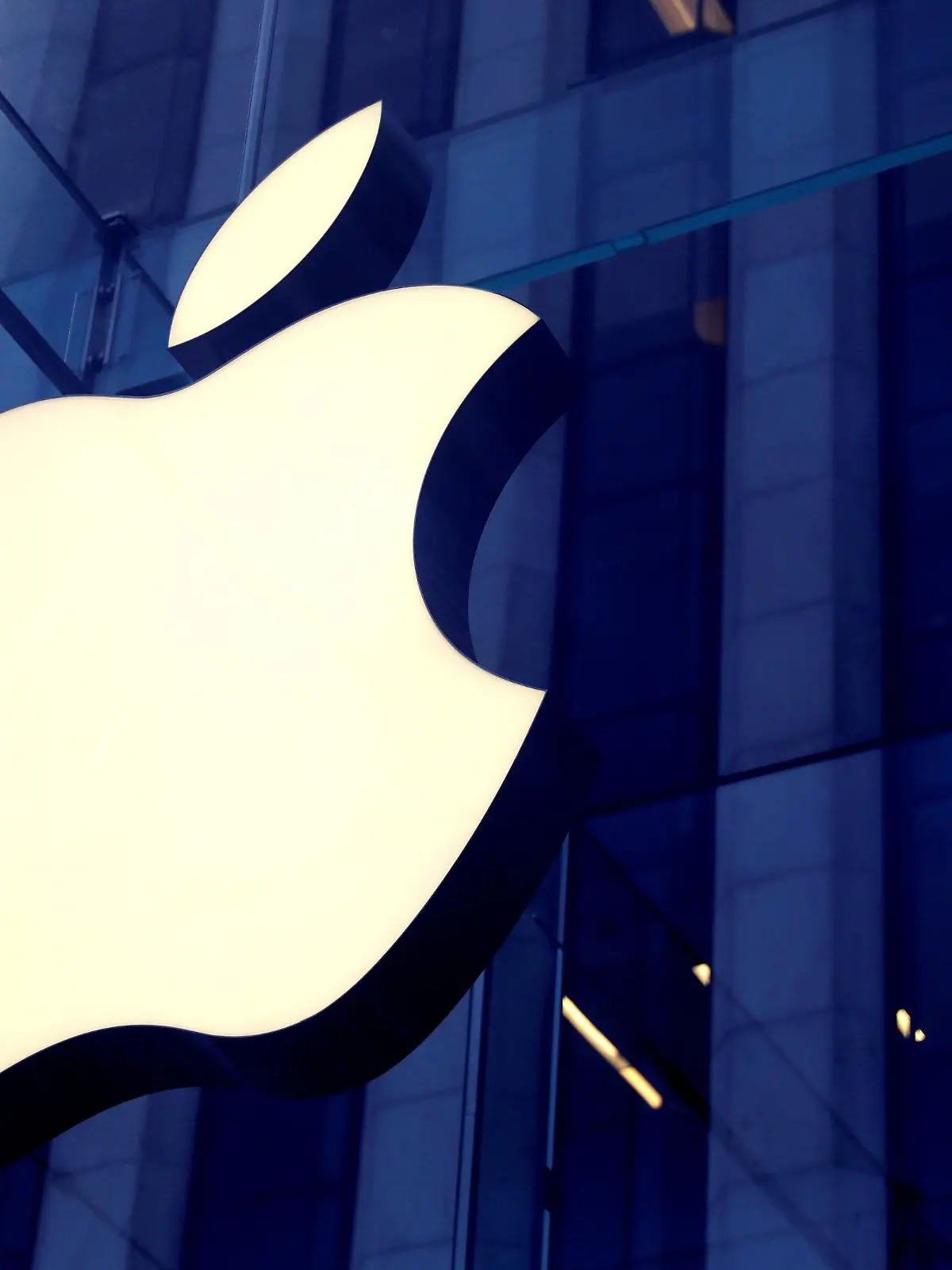 FILE PHOTO: The Apple Inc logo is seen hanging at the entrance to the Apple store on 5th Avenue in Manhattan, New York, U.S., October 16, 2019. REUTERS/Mike Segar/File Photo