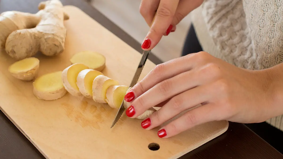sliced ginger root on a wooden cutting board