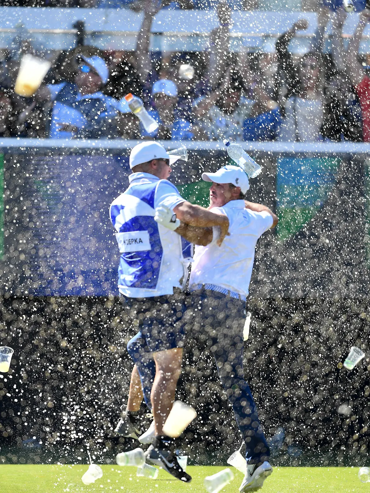 ADELAIDE, AUSTRALIA - APRIL 23: Chase Koepka of the Smash celebrates a hole in one with his caddie on the 12th showered in beer from the crowd during day three of Liv Golf Adelaide at The Grange Golf Course on April 23, 2023 in Adelaide, Australia. (Photo by Mark Brake/Getty Images)