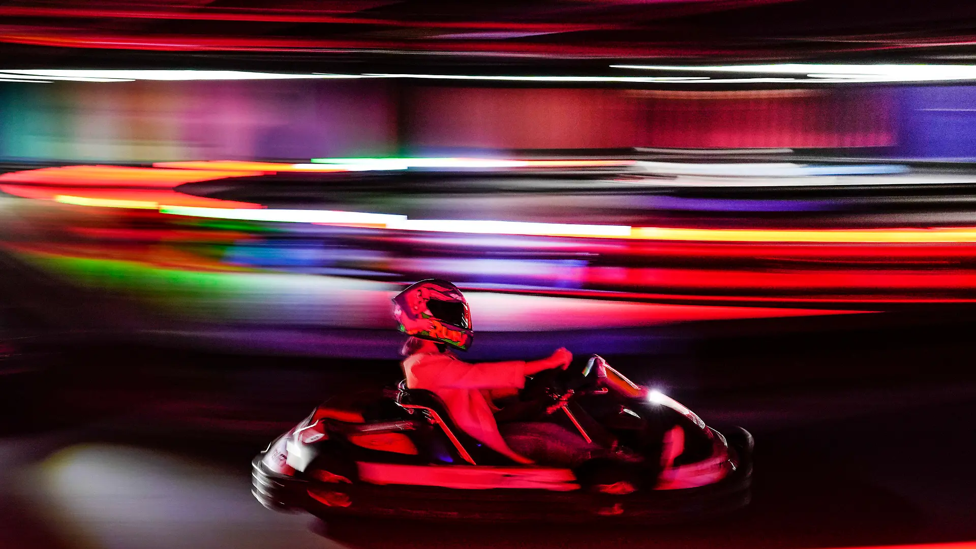 A woman drives a go-kart during the inauguration of Foodkart Caracas, the first indoor kart track in Caracas, Venezuela, Saturday, March 4, 2023. (AP Photo/Matias Delacroix)