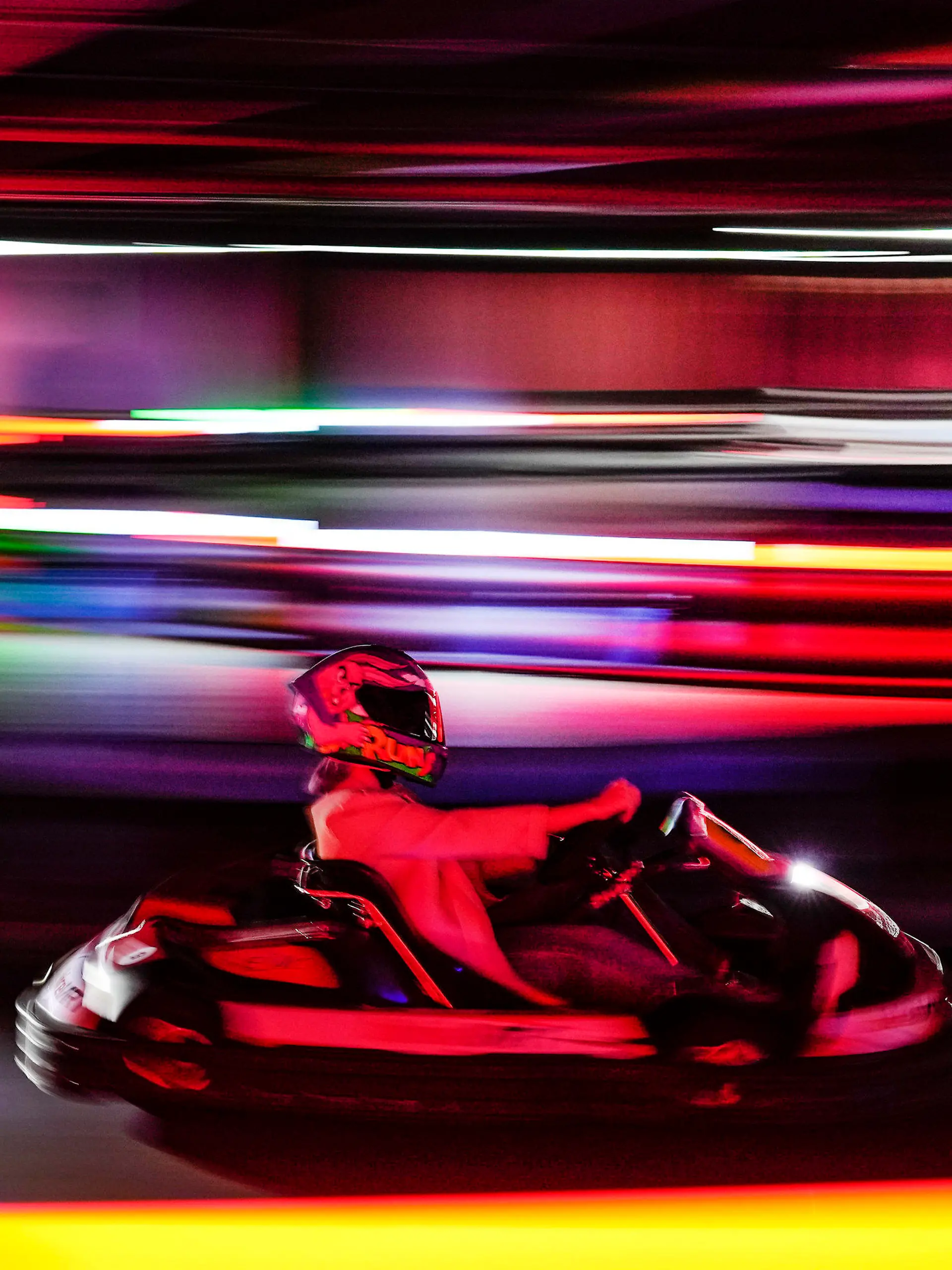 A woman drives a go-kart during the inauguration of Foodkart Caracas, the first indoor kart track in Caracas, Venezuela, Saturday, March 4, 2023. (AP Photo/Matias Delacroix)