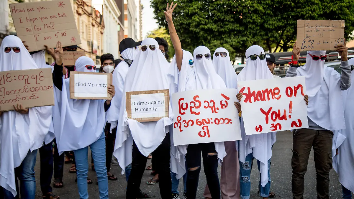  February 10, 2021, Yangon, Myanmar: Protesters seen wearing ghost costumes and holding placards during the 5th day Military Coup demonstrations..Thousands of people took to the streets of Yangon on the fifth day of protest against the military coup and demanded the release of Aung San Suu Kyi. Myanmar s military detained State Counsellor of Myanmar Aung San Suu Kyi on February 01, 2021 and declared a state of emergency while seizing the power in the country for a year after losing the election against the National League for Democracy Yangon Myanmar - ZUMAs197 20210210_zaa_s197_091 Copyright: xTheintxMonxSoex