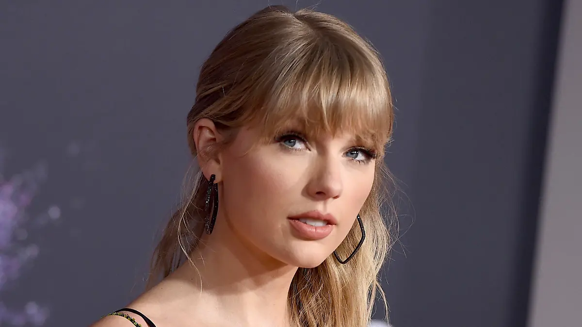 FILE - This Nov. 24, 2019 file photo shows Taylor Swift at the American Music Awards in Los Angeles. Swift announced online that she’s dropping the first of her re-recorded albums. She said “Fearless: Taylor’s Version” features re-recorded songs from her sophomore album, “Fearless.” The new set will also contain six never-before released songs. Swift will also release a new version of her song “Love Story” from “Fearless” on Thursday at midnight. (Photo by Jordan Strauss/Invision/AP, File)