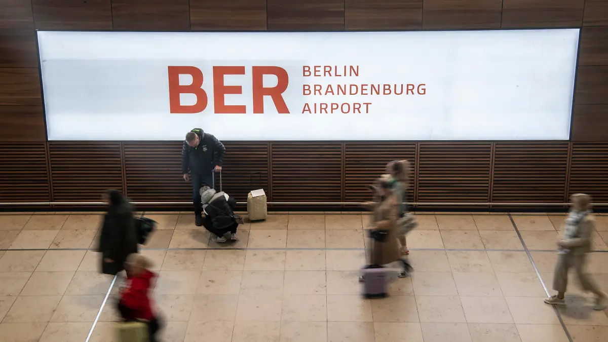 27.03.2023, Brandenburg, Schönefeld: Reisende gehen während des bundesweiten Warnstreiks im Bahn- und Luftverkehr durch das Terminal im Flughafen BER. Dort mussten nur wenige Flüge gestrichen werden. Mit einem großangelegten bundesweiten Warnstreik haben die Gewerkschaften EVG und Verdi am Montag weite Teile des öffentlichen Verkehrs lahmgelegt. Foto: Paul Zinken/dpa +++ dpa-Bildfunk +++