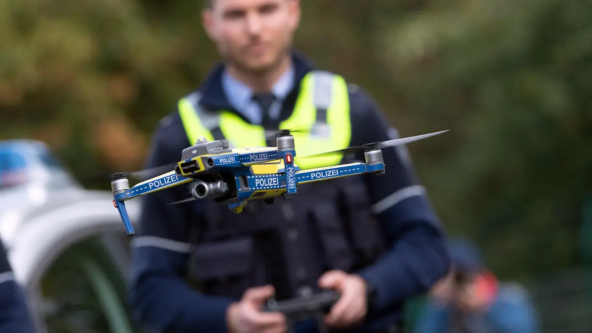 ARCHIV - 12.10.2020, Nordrhein-Westfalen, Neuss: Eine Drohne für die Polizei wird von einem Polizeibeamten gesteuert. Nach einer Pilotphase gehen Drohnen in der nordrhein-westfälischen Polizei in den regulären Einsatz. (zu dpa: «Landesbehörde: Polizei-Drohnen haben besondere Rechte») Foto: Federico Gambarini/dpa +++ dpa-Bildfunk +++