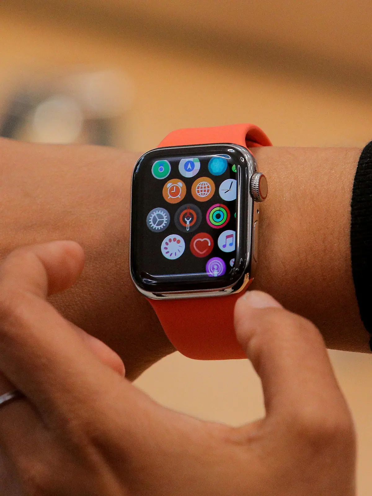FILE PHOTO: An Apple Store employee shows the new Series 5 Apple Watch during the preview of the redesigned and reimagined Apple Fifth Avenue store in New York, U.S., September 19, 2019. REUTERS/Brendan McDermid/File Photo/File Photo