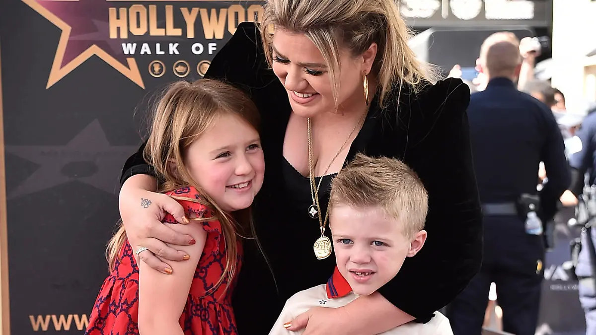 Singer and talk show host Kelly Clarkson and her children River Rose, left, and Remington, right, pose atop Clarkson's new star on the Hollywood Walk of Fame during a ceremony on Monday, Sept. 19, 2022, in Los Angeles. (Photo by Jordan Strauss/Invision/AP)