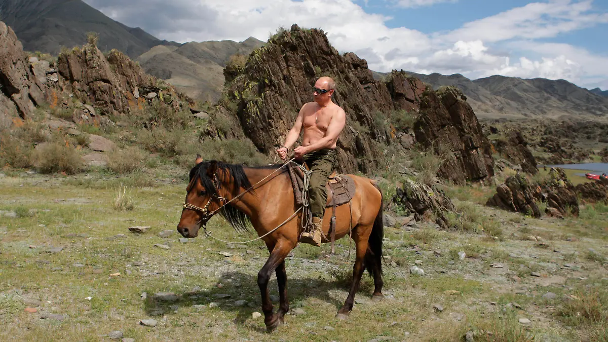 FILE - In this file pool photo taken on Monday, Aug. 3, 2009, the then Russian Prime Minister Vladimir Putin ia seen riding a horse while traveling in the mountains of the Siberian Tyva region (also referred to as Tuva), Russia, during his short vacation. After 18 years as Russia’s leader _ and with another six-year term sure to follow a March election _ Putin doesn’t show the appetites or vulnerabilities that can personalize Western politics, even when staged or spun. If he has moments of merriment or melancholy, they happen in private. (Alexei Druzhinin, Sputnik, Kremlin Pool Photo via AP, file)