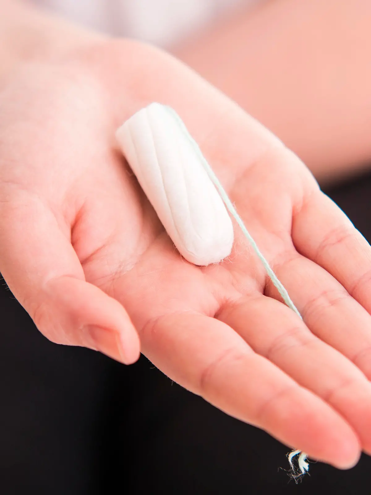 Tampo on womans hand before intravaginal aplication - colse up
