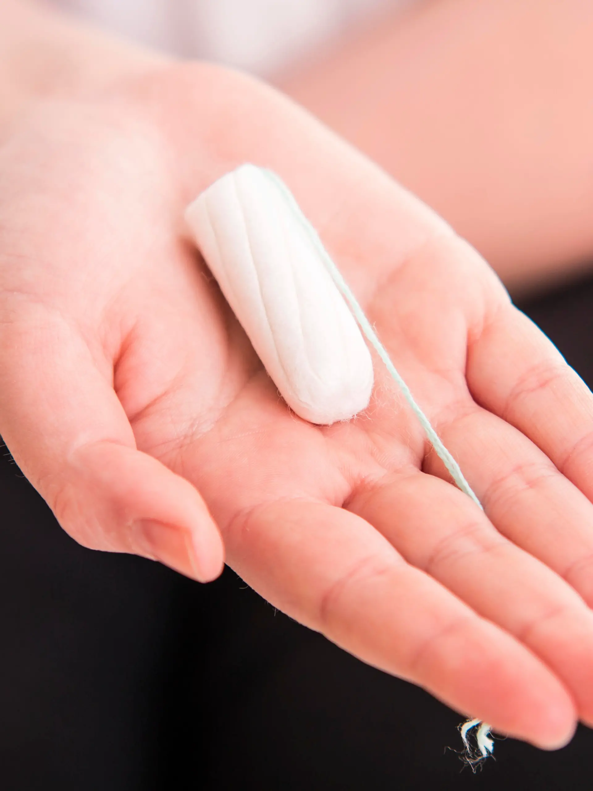 Tampo on womans hand before intravaginal aplication - colse up
