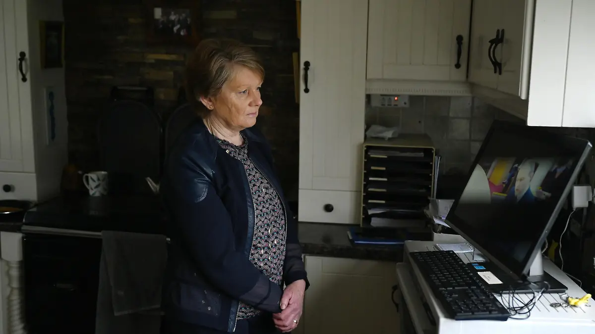 Historian Catherine Corless watches Taoiseach Micheal Martin speaking during a Government webinar meeting for survivors and supporters of Church-run mother and baby homes where he outlines the first look at the report by the Commission of Investigation into the institutions before it is formally published, in Tuam, Ireland, January 12, 2021. REUTERS/Clodagh Kilcoyne