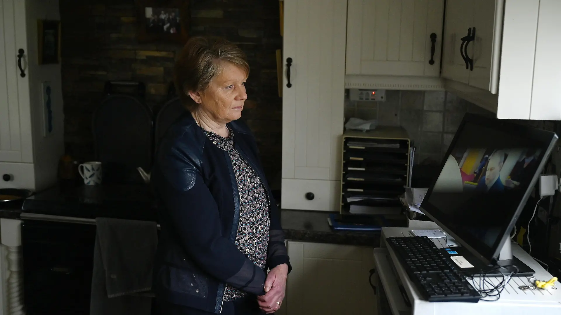 Historian Catherine Corless watches Taoiseach Micheal Martin speaking during a Government webinar meeting for survivors and supporters of Church-run mother and baby homes where he outlines the first look at the report by the Commission of Investigation into the institutions before it is formally published, in Tuam, Ireland, January 12, 2021. REUTERS/Clodagh Kilcoyne