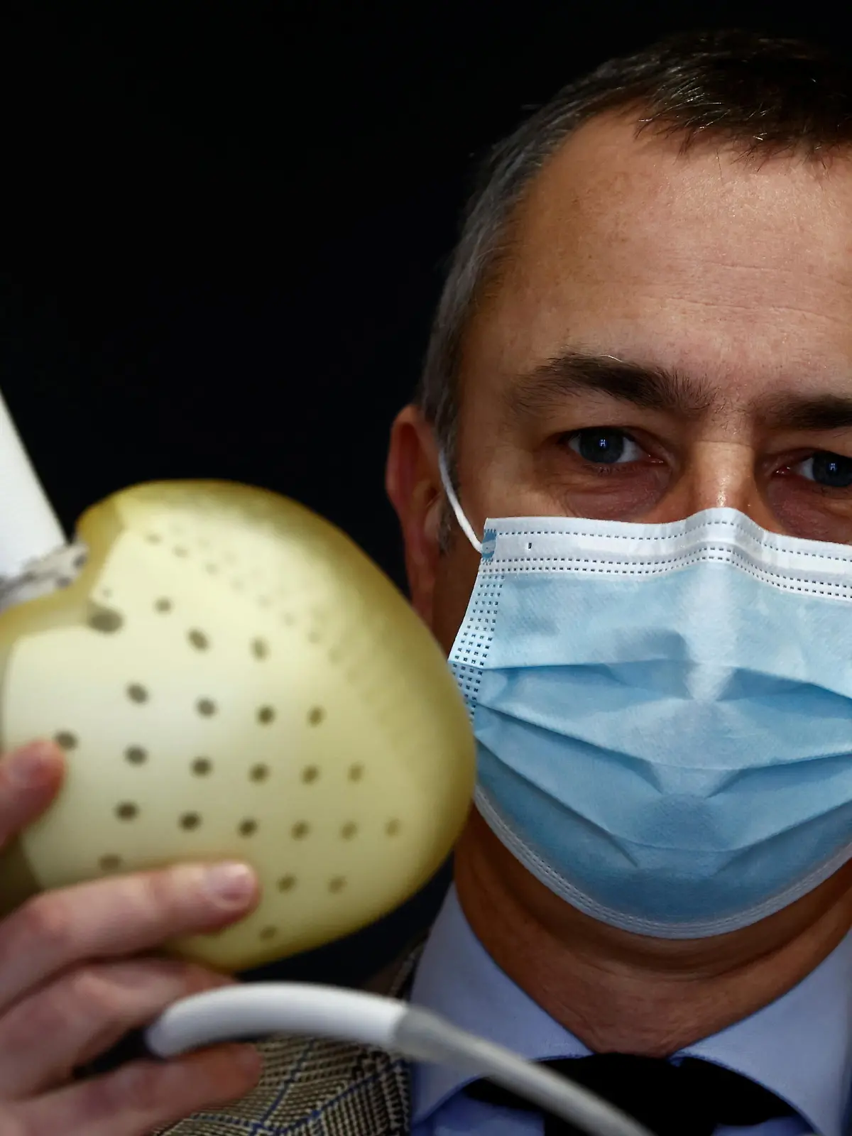 Chief Executive Officer of French artificial heart manufacturer Carmat, Stephane Piat, poses holding an artificial heart during an interview with Reuters in Velizy, near Paris, January 11, 2021.  REUTERS/Christian Hartmann