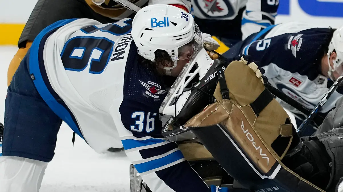 Winnipeg Jets center Morgan Barron (36) gets his face cut on the skate of Vegas Golden Knights goaltender Laurent Brossoit (39) during the first period of Game 1 of an NHL hockey Stanley Cup first-round playoff series Tuesday, April 18, 2023, in Las Vegas. (AP Photo/John Locher)