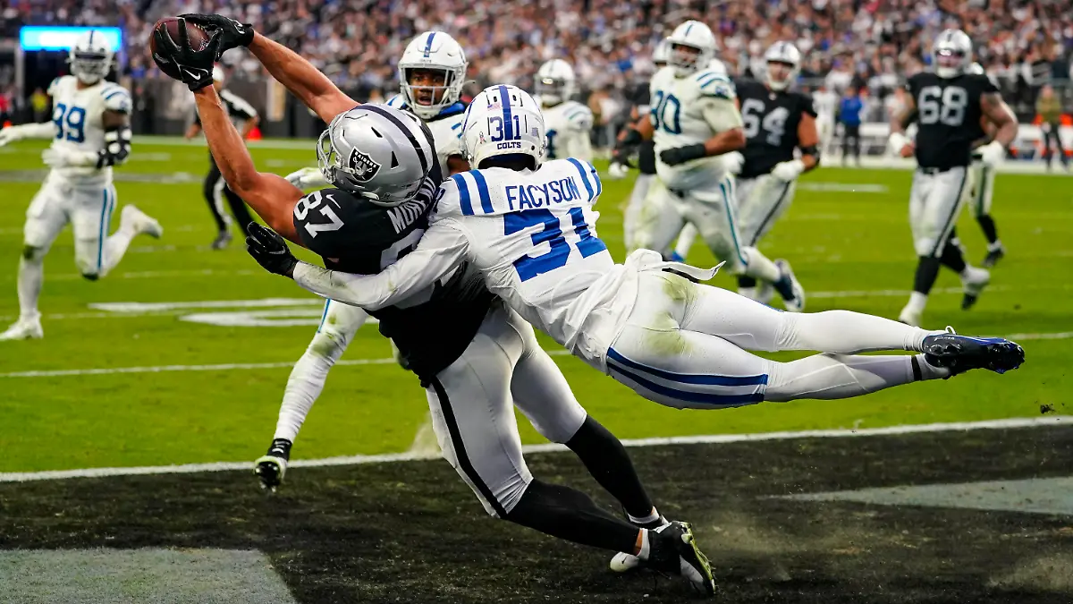 ARCHIV - 13.11.2022, USA, Las Vegas: Foster Moreau (87) von Las Vegas Raiders fängt einen Touchdown, während er von Indianapolis Colts Cornerback Brandon Facyson (31) angegriffen wird. (Archiv). Moreau hat nun eine Krebserkrankung öffentlich gemacht (zu dpa: «Bei Routinekontrolle festgestellt: NFL-Profi an Krebs erkrankt») Foto: Matt York/AP/dpa +++ dpa-Bildfunk +++