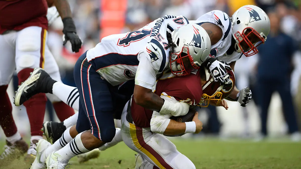 FILE - New England Patriots outside linebacker Dont'a Hightower (54) and New England Patriots defensive end Michael Bennett (77) sack Washington Redskins quarterback Colt McCoy (12) during the second half of an NFL football game, Sunday, Oct. 6, 2019, in Washington. Dont'a Hightower is making a quiet exit to a memorable career with the New England Patriots. The veteran linebacker, who did not play last season, announced his retirement Tuesday, March 21, 2023, in an essay posted in the Players' Tribune. (AP Photo/Nick Wass, File)