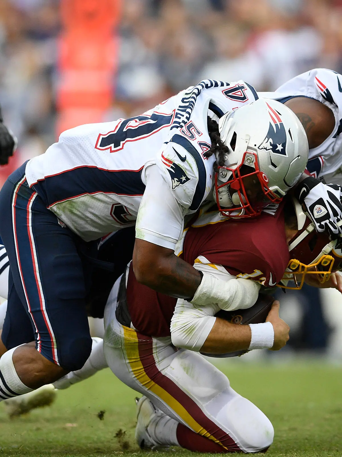 FILE - New England Patriots outside linebacker Dont'a Hightower (54) and New England Patriots defensive end Michael Bennett (77) sack Washington Redskins quarterback Colt McCoy (12) during the second half of an NFL football game, Sunday, Oct. 6, 2019, in Washington. Dont'a Hightower is making a quiet exit to a memorable career with the New England Patriots. The veteran linebacker, who did not play last season, announced his retirement Tuesday, March 21, 2023, in an essay posted in the Players' Tribune. (AP Photo/Nick Wass, File)