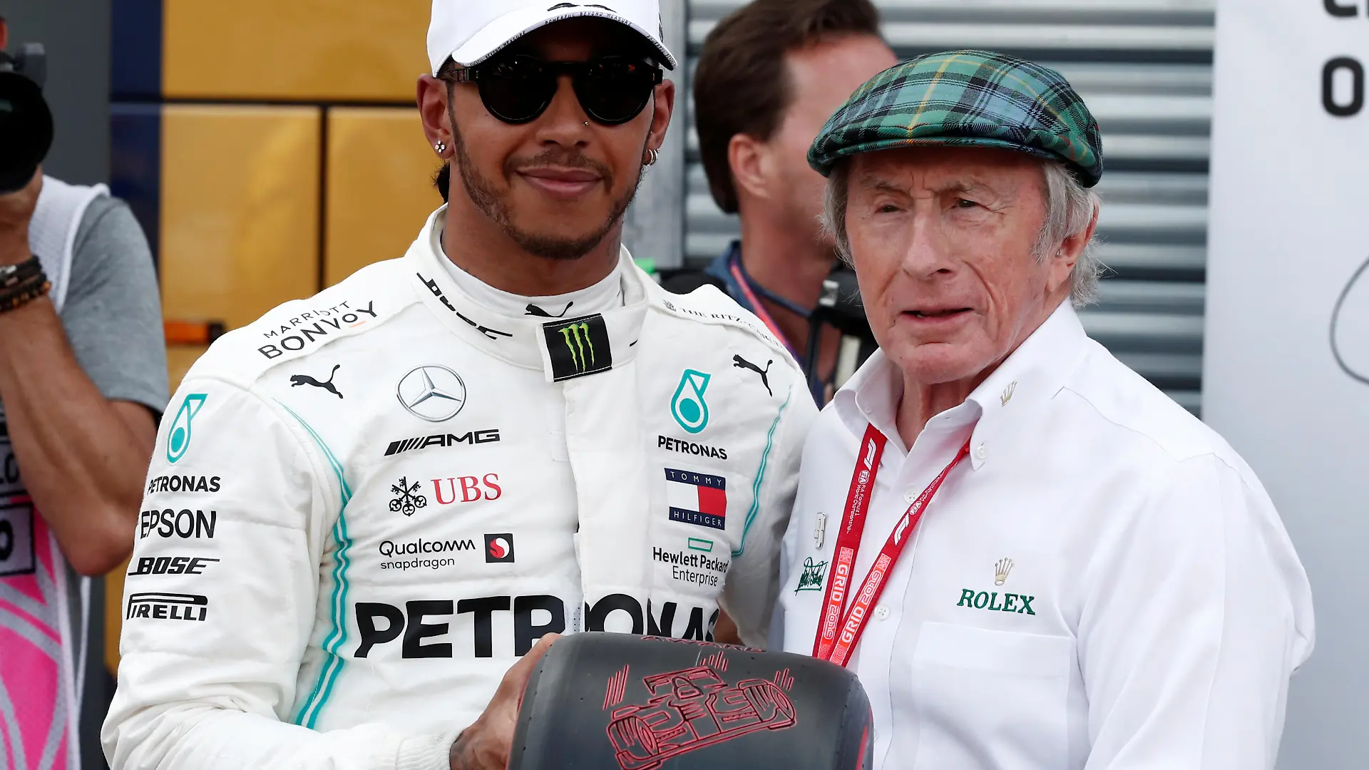 Formula One F1 - Monaco Grand Prix - Circuit de Monaco, Monte Carlo, Monaco - May 25, 2019 Mercedes' Lewis Hamilton is presented a tire by Jackie Stewart after qualifying in pole position REUTERS/Benoit Tessier