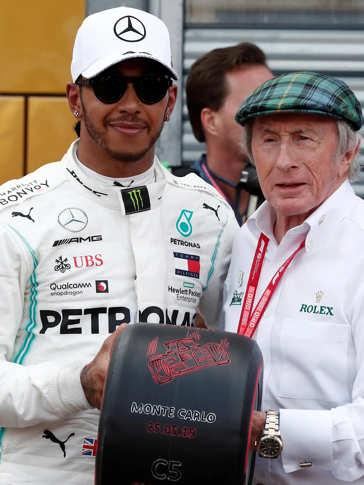 Formula One F1 - Monaco Grand Prix - Circuit de Monaco, Monte Carlo, Monaco - May 25, 2019   Mercedes' Lewis Hamilton is presented a tire by Jackie Stewart after qualifying in pole position   REUTERS/Benoit Tessier