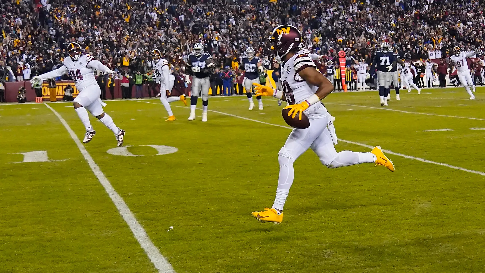 Washington Commanders cornerback Kendall Fuller (29) running towards the end zone to score a touch down after his interception against the Dallas Cowboys during the first half an NFL football game, Sunday, Jan. 8, 2023, in Landover, Md. (AP Photo/Alex Brandon)