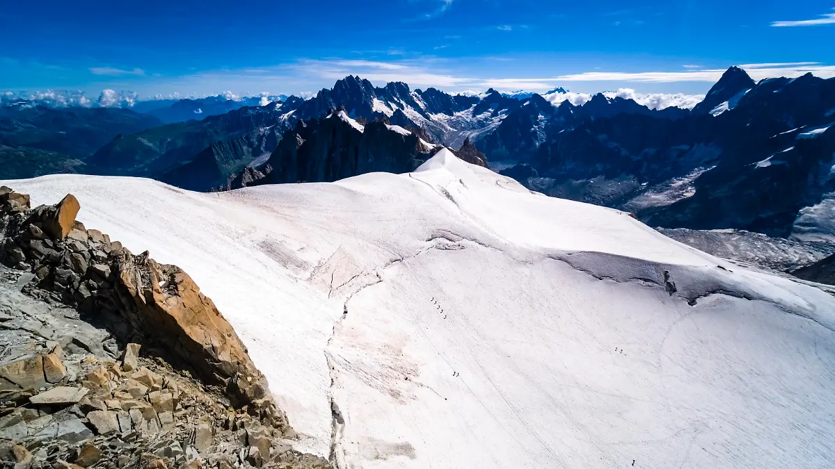 Aerial view from the Panoramic Mont Blanc cable car between Aiguille du Midi and Pointe Helbronner of the GÃ ant Glacier, alpinists crossing the ice. Chamonix Haute-Savoie France FB_2022_2157