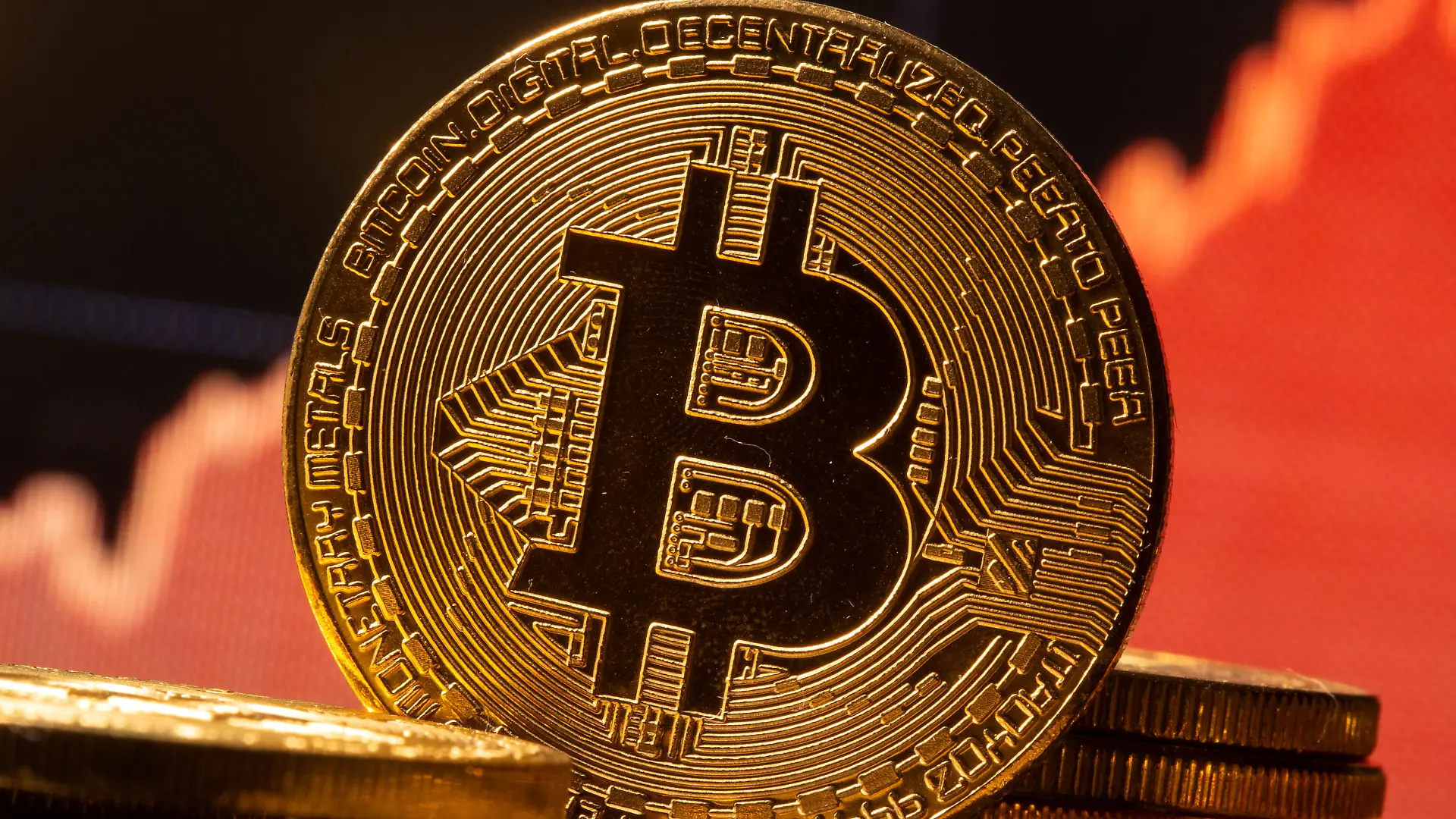 FILE PHOTO: A representation of virtual currency Bitcoin is seen in front of a stock graph in this illustration taken November 19, 2020. REUTERS/Dado Ruvic/Illustration/File Photo