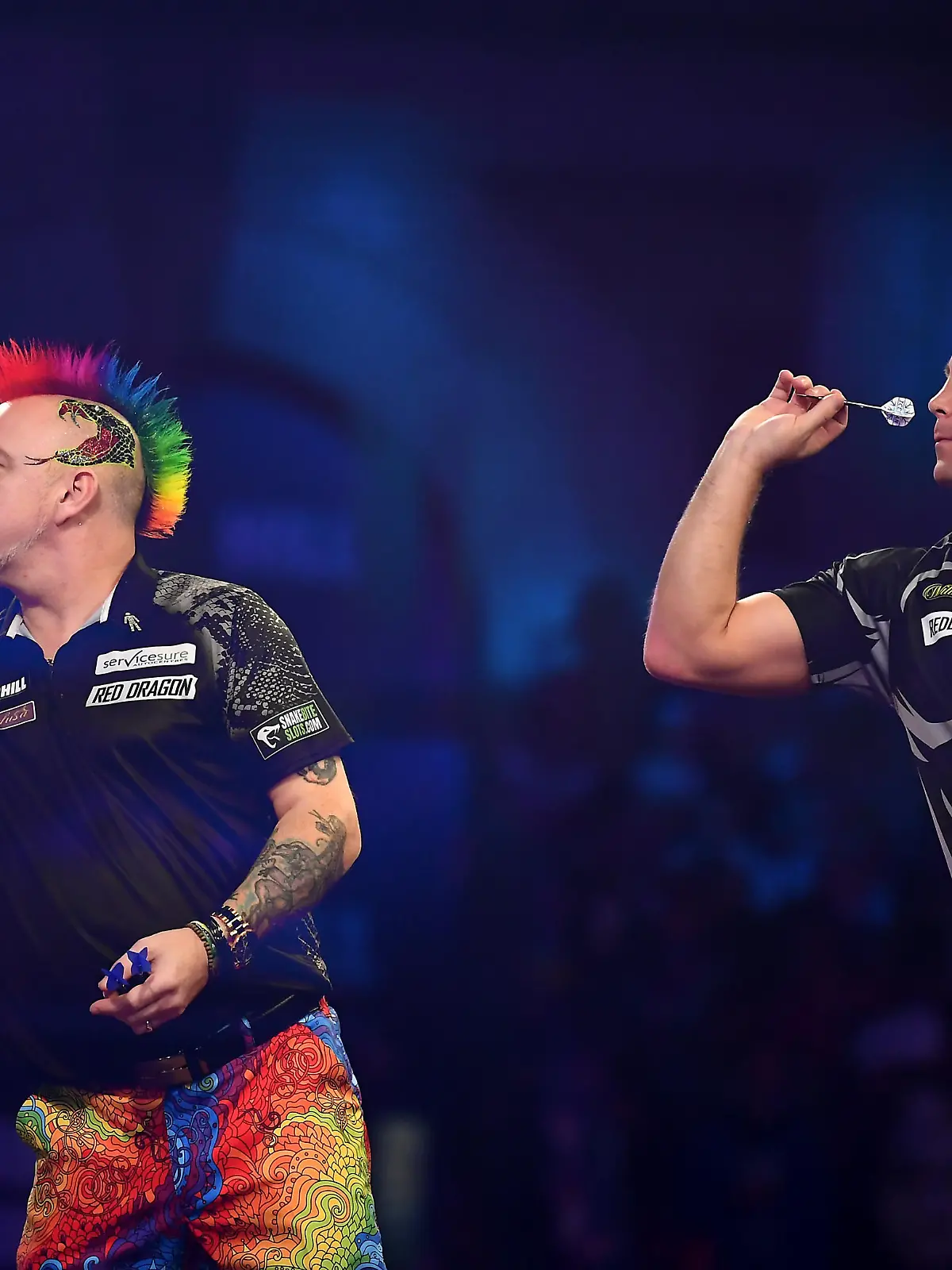 LONDON, ENGLAND - DECEMBER 30: (EDITORS NOTE: Multiple exposures were combined in camera to produce this image.) Peter Wright and Gerwyn Price in action  during the Semi-Final match between Peter Wright and Gerwyn Price on Day 15 of the 2020 William Hill World Darts Championship at Alexandra Palace on December 30, 2019 in London, England. (Photo by Alex Davidson/Getty Images)