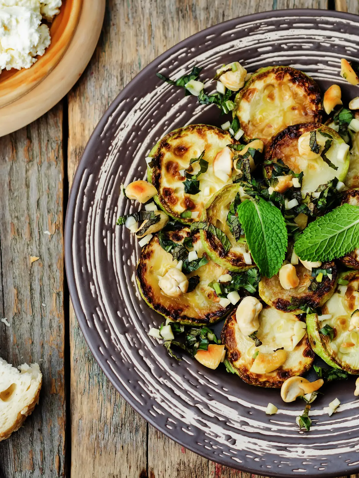 zucchini Basil mint cashews salad with ricotta and fresh bread. the toning. selective focus