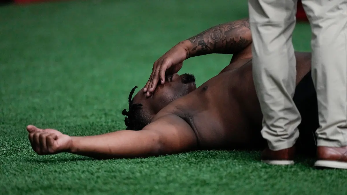 A trainer works with former Georgia defensive lineman Jalen Carter after he runs football drills during Georgia's Pro Day, Wednesday, March 15, 2023, in Athens, Ga. (AP Photo/John Bazemore)