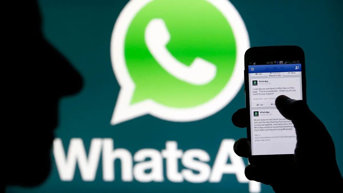 A Whatsapp App logo is seen behind a Samsung Galaxy S4 phone that is logged on to Facebook in the central Bosnian town of Zenica, February 20, 2014. Facebook Inc will buy fast-growing mobile-messaging startup WhatsApp for $19 billion in cash and stock in a landmark deal that places the world's largest social network closer to the heart of mobile communications and may bring younger users into the fold. REUTERS/Dado Ruvic (BOSNIA AND HERZEGOVINA - Tags: BUSINESS)