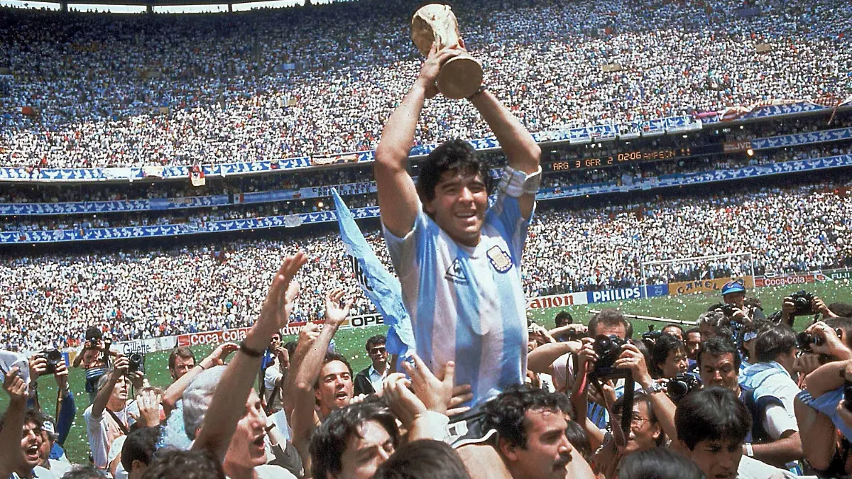 FILE - In this June 29, 1986, file photo, Diego Maradona holds up his team's trophy after Argentina's 3-2 victory over West Germany at the World Cup final soccer match at Azteca Stadium in Mexico City. The Argentine soccer great who was among the best players ever and who led his country to the 1986 World Cup title died from a heart attack on Wednesday, Nov. 25, 2020, at his home in Buenos Aires. He was 60. (AP Photo/Carlo Fumagalli, File)