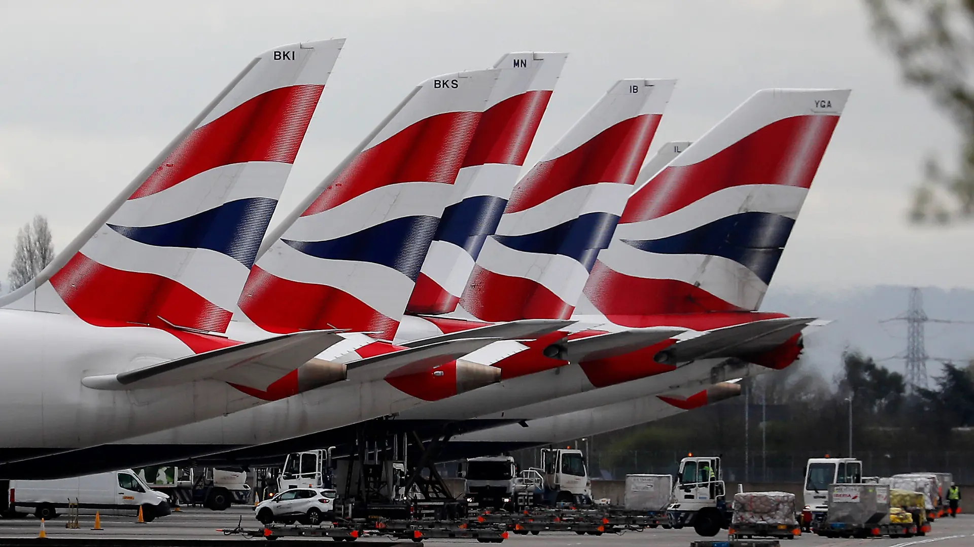 FILE - In this Wednesday, March 18, 2020 file photo, British Airways planes parked at Terminal 5 Heathrow airport in London. British Airways’ parent company said Thursday, Sept. 10, 2020 it is to cut flights due to coronavirus travel restrictions and quarantine requirements and confirmed that it is raising 2.7 billion euros ($3.2 billion) through the sale of new shares. (AP Photo/Frank Augstein, File)