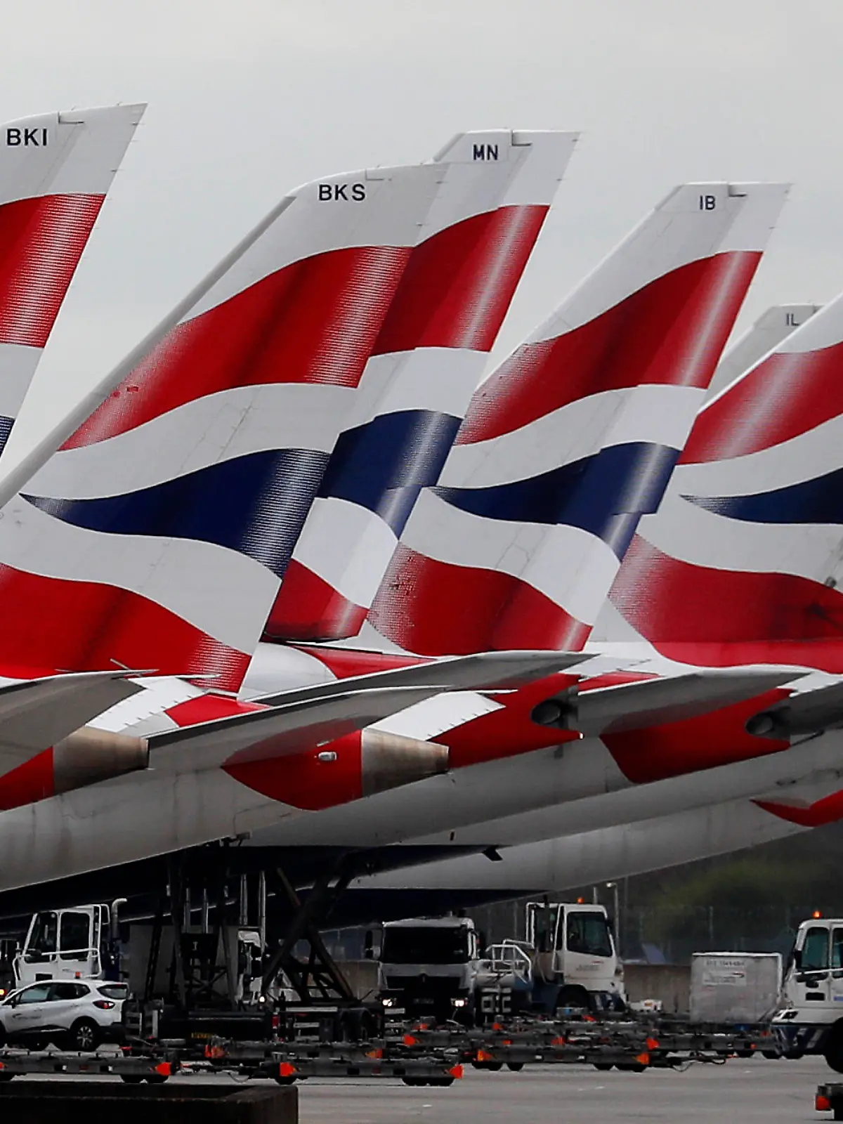 FILE - In this Wednesday, March 18, 2020 file photo, British Airways planes parked at Terminal 5 Heathrow airport in London. British Airways’ parent company said Thursday, Sept. 10, 2020 it is to cut flights due to coronavirus travel restrictions and quarantine requirements and confirmed that it is raising 2.7 billion euros ($3.2 billion) through the sale of new shares. (AP Photo/Frank Augstein, File)