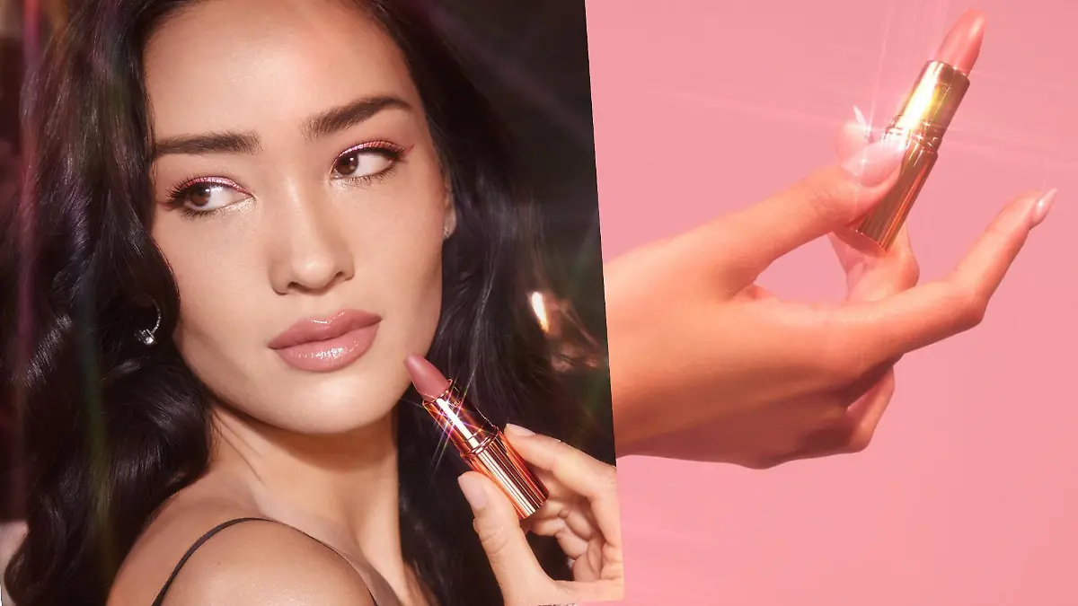 Frau, die mit einem Lippenstift in der Hand posiert und ein Lippenstift in einer Hand.