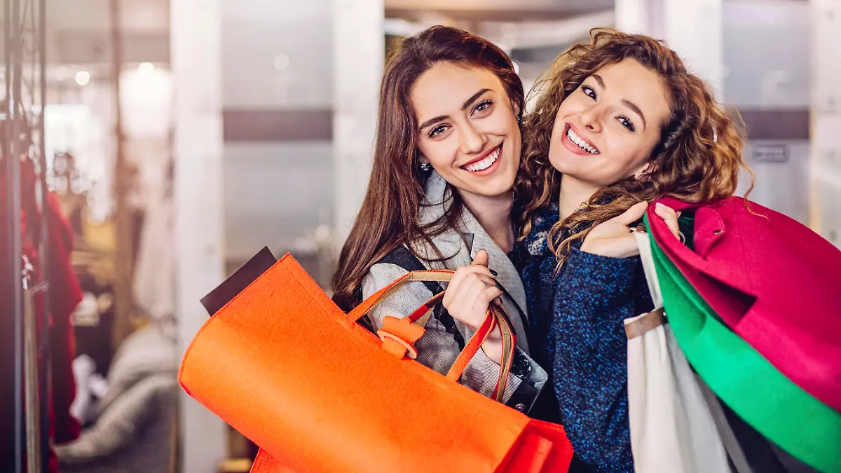 Smiling women with shopping bags