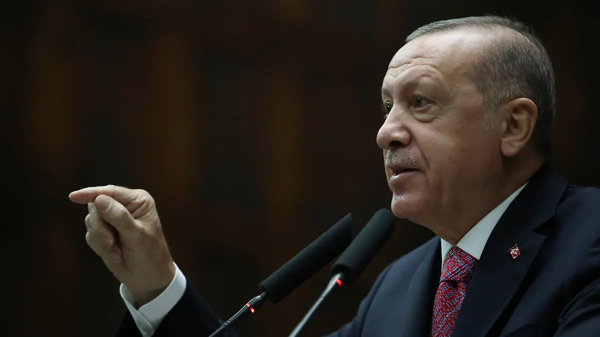 Turkey's President Recep Tayyip Erdogan addresses the legislators from his ruling party, in Ankara, Turkey, Wednesday, Nov. 25, 2020. Erdogan said a Turkish-developed vaccine against COVID-19 could be ready for use by April. Erdogan also said that once ready, Turkey planned to share the vaccine with world countries. (Turkish Presidency via AP, Pool)