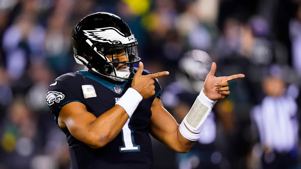 FILE — Philadelphia Eagles quarterback Jalen Hurts celebrates a touchdown run by Kenneth Gainwell during the first half of the team's NFL football game against the Green Bay Packers on Nov. 27, 2022, in Philadelphia. Jalen Hurts is set to sign one of the richest deals in NFL history, agreeing to a five-year, $255 million extension with the Philadelphia Eagles, including $179.3 million guaranteed, a person with knowledge of the situation told The Associated Press. The Eagles announced on Monday, April 17,  “QB1 is here to stay,” but terms were not yet announced, according to the person who spoke to the AP on condition of anonymity because the deal was not yet final. (AP Photo/Chris Szagola, File)