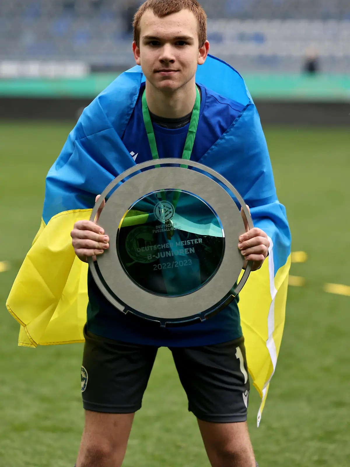BIELEFELD, GERMANY - APRIL 16: Artem Zaloha of Bielefeld celebrates with the trophy after winning 2-1 the B Juniors German Championship Final between Arminia Bielefeld and VfL Wolfsburg at Schueco Arena on April 16, 2023 in Bielefeld, Germany. (Photo by Christof Koepsel/Getty Images)