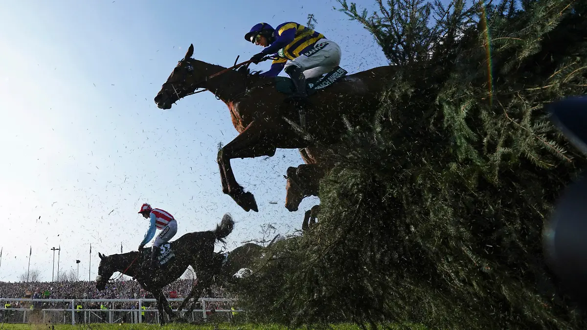 Derek Fox on Corach Rambler, top, clears the Chair fence on the way to winning the Grand National horse race at Aintree Racecourse Liverpool, England, Saturday, April 15, 2023. The iconic Grand National race which is run over fences is 4 miles, 2 ½ furlongs has its origins in the 1839 Grand Liverpool Steeplechase. (AP Photo/Jon Super)