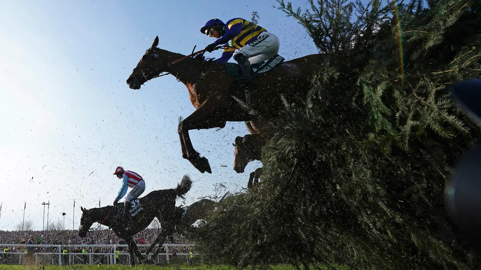 Derek Fox on Corach Rambler, top, clears the Chair fence on the way to winning the Grand National horse race at Aintree Racecourse Liverpool, England, Saturday, April 15, 2023. The iconic Grand National race which is run over fences is 4 miles, 2 ½ furlongs has its origins in the 1839 Grand Liverpool Steeplechase. (AP Photo/Jon Super)